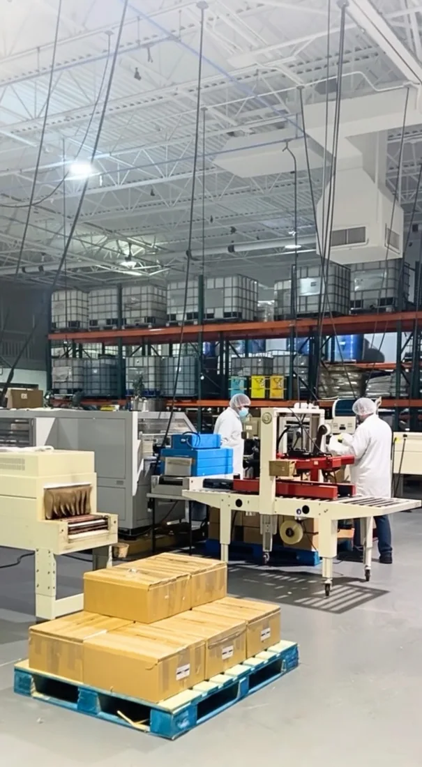 Production image from the original GP Labs website: manufacturing equipment, operators and packaged cartons.